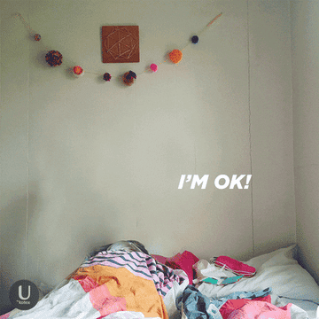Someone lying in bed saying &quot;I&#x27;m ok!&quot;
