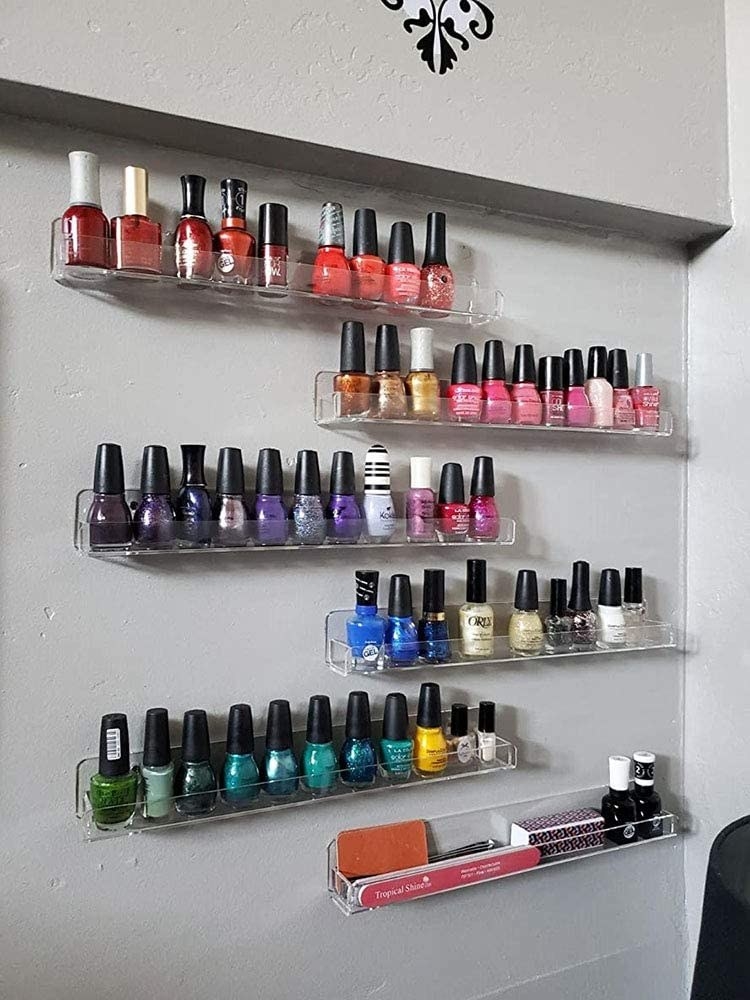 Several bottles of nail polish on the shelves