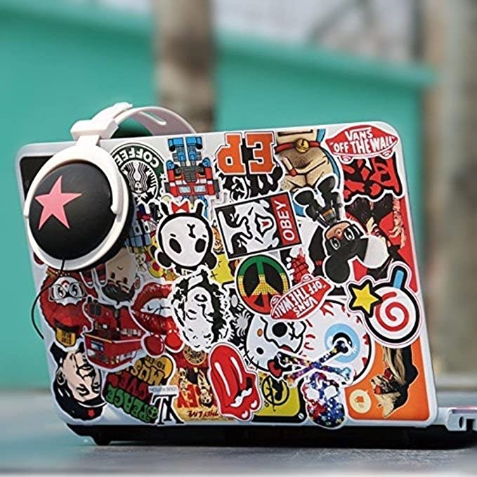 Laptop covered with stickers.