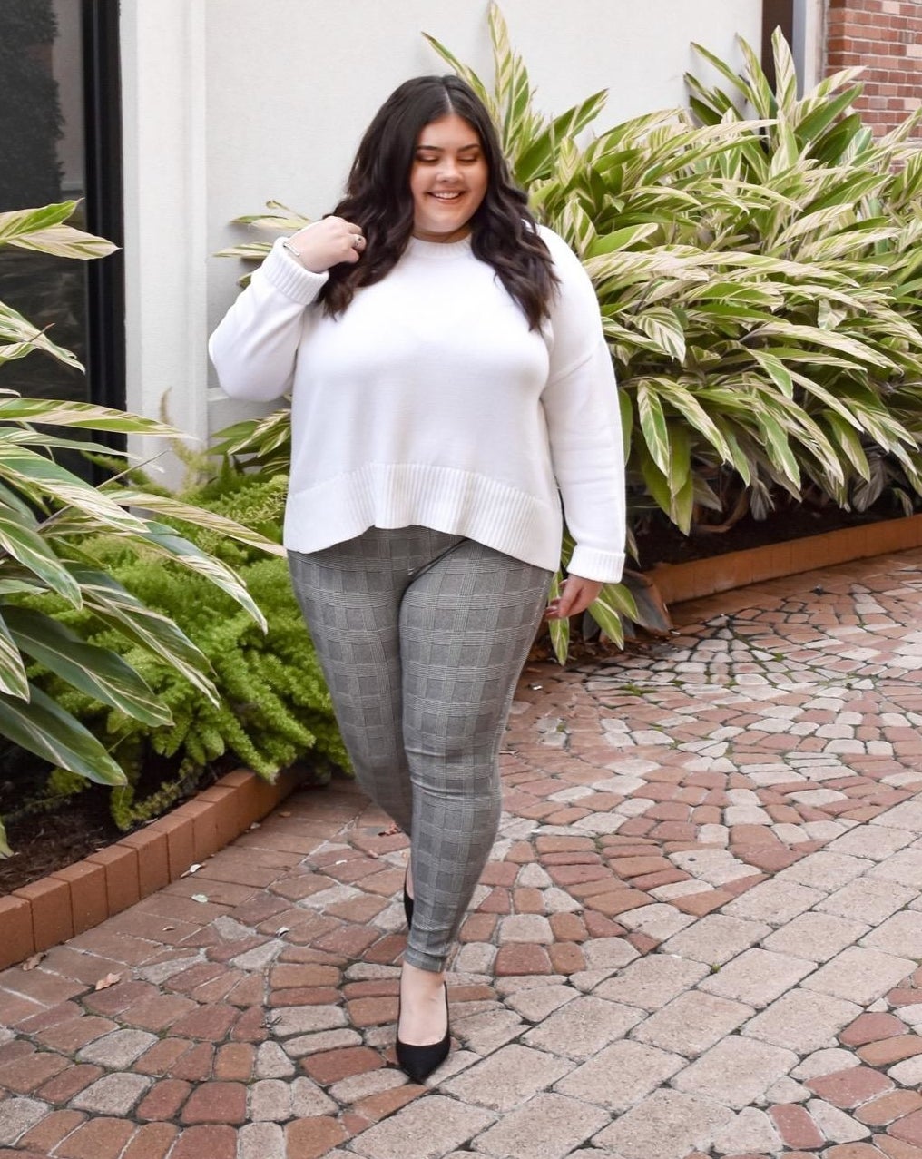 a reviewer wearing the plaid leggings in gray