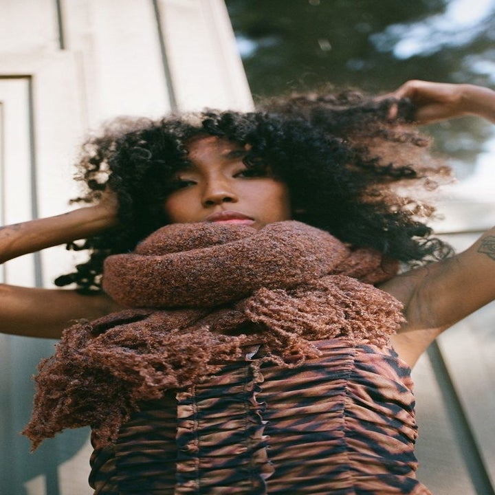 model wears fuzzy brown scarf 