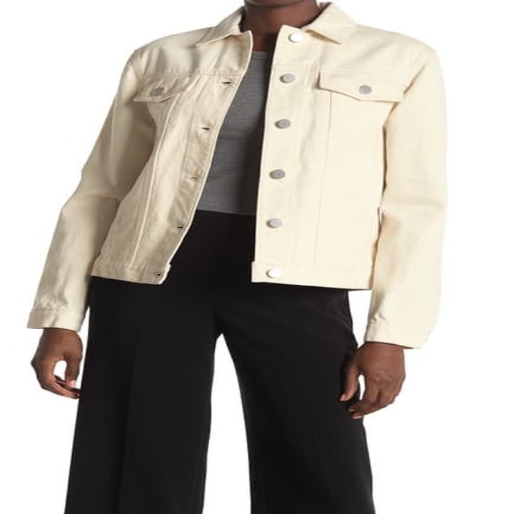 model wears cream denim jacket 