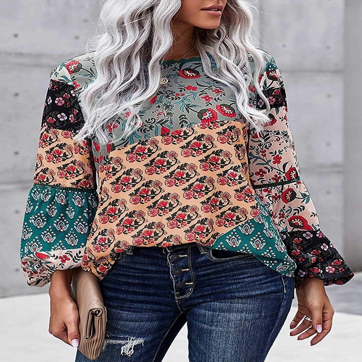 A model wearing the top in various teal, mint, plack, pink, and peach floral prints