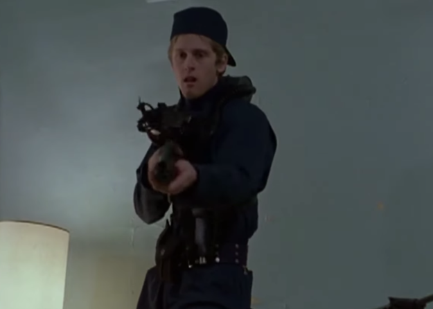 A man holds a rifle as zombies run towards him in the movie "Dawn of the Dead."