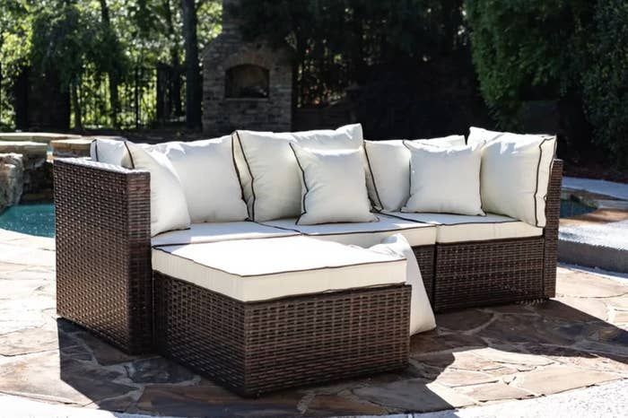 the patio sectional in brown with cream cushions
