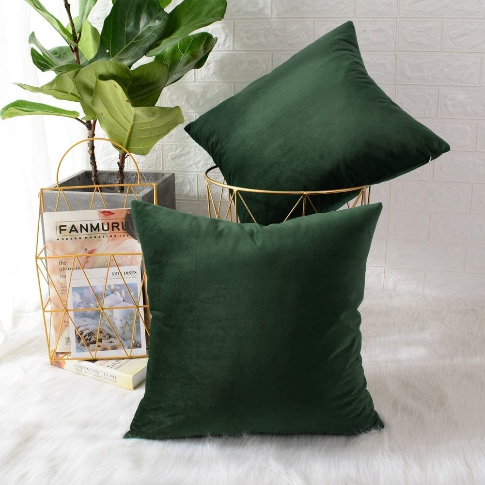 Two small throw pillows on a faux fur rug