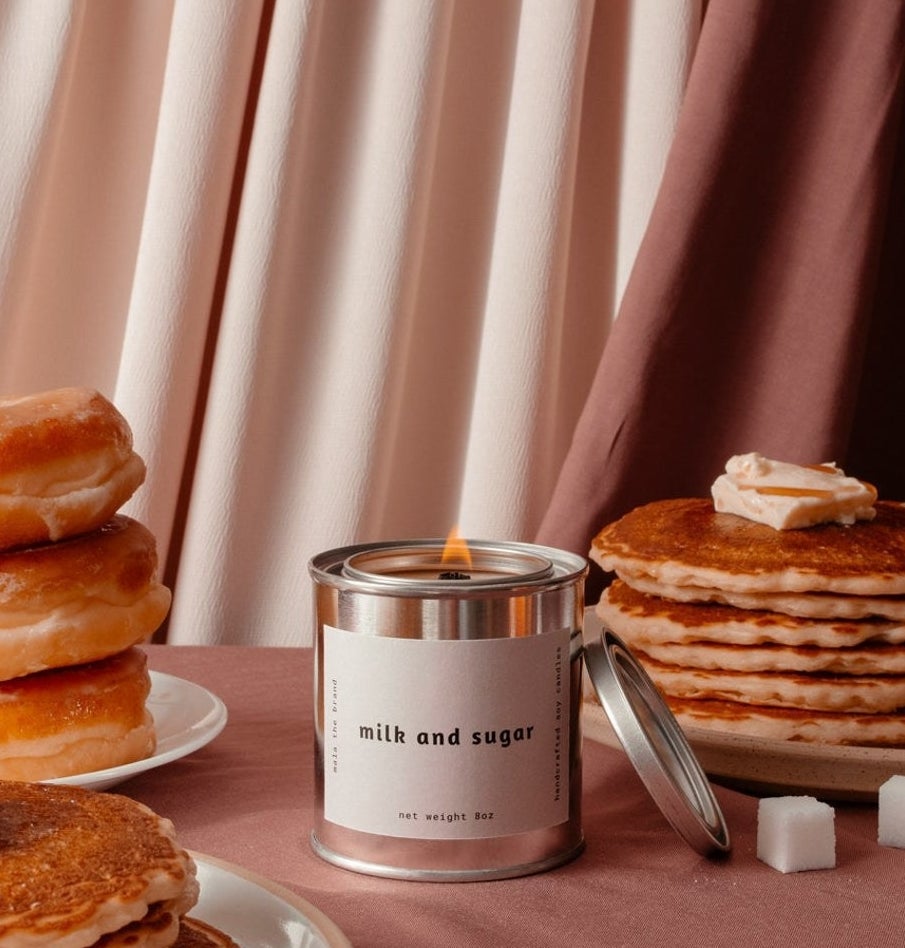 The candle surrounded by pancakes and donuts