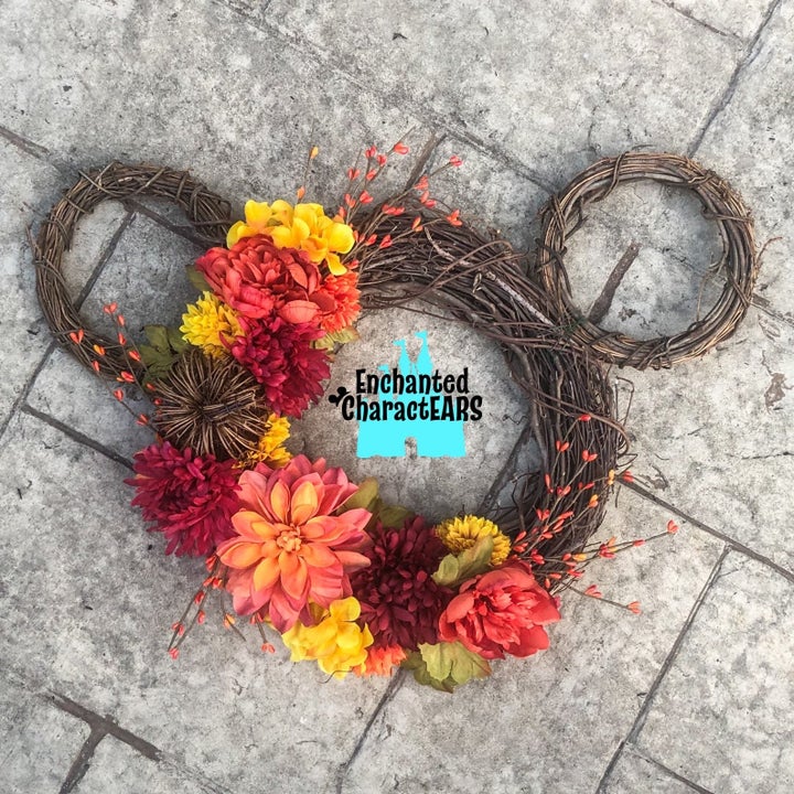 a mickey-shaped wreath with fall florals on it