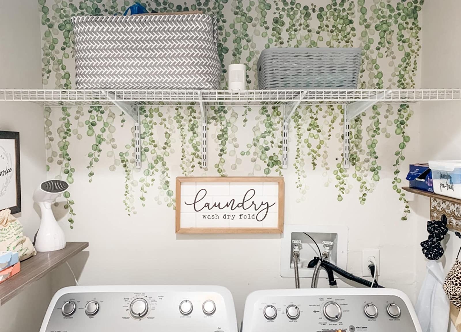 reviewer image of the roommates string of pearls vine decals on a laundry room wall