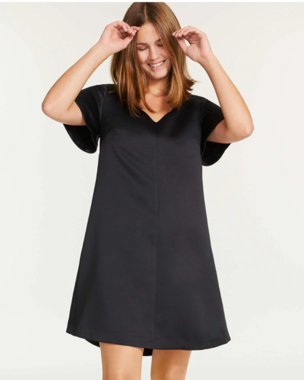 A person wearing a satiny T-shirt dress