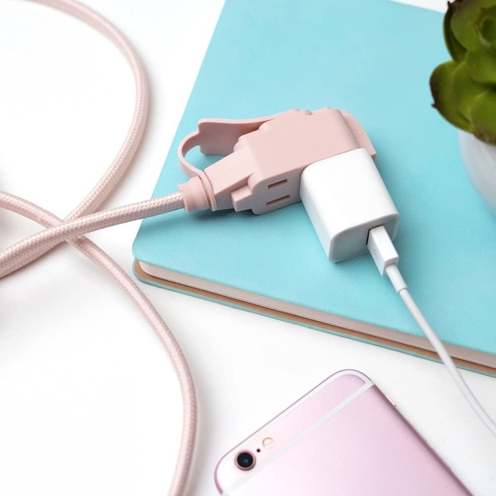 An iPhone plugged into the extension cord