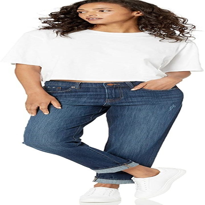 A model wearing the medium wash cuffed jeans