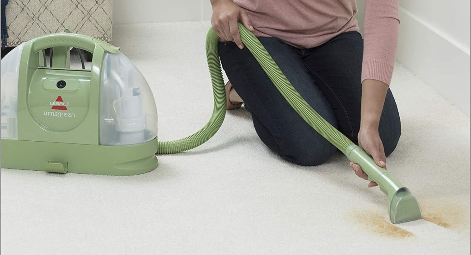 person cleaning up a stain on the carpet