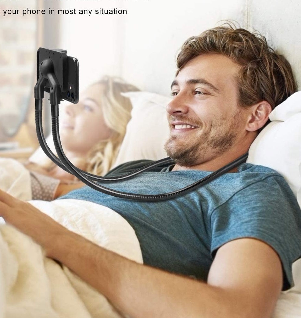 A person wearing the phone mount in bed