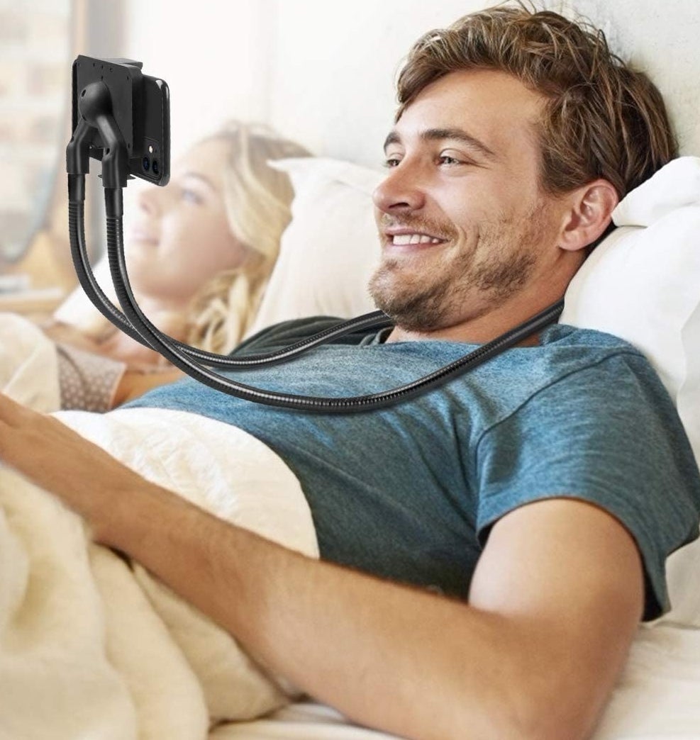 A person wearing the phone mount in bed