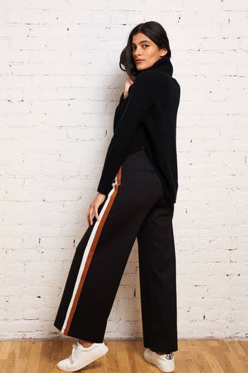 Back view of a model wearing the pants in black
