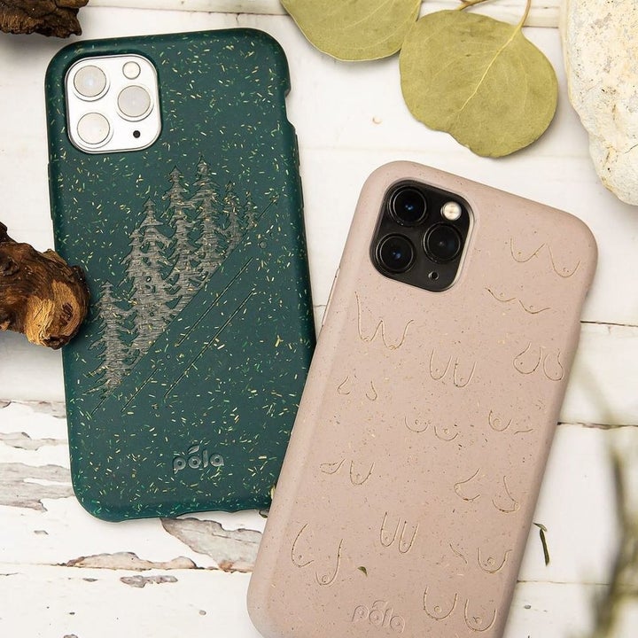 A green Pela iPhone case with a tree print and a tan Pela iPhone case with a boob print 