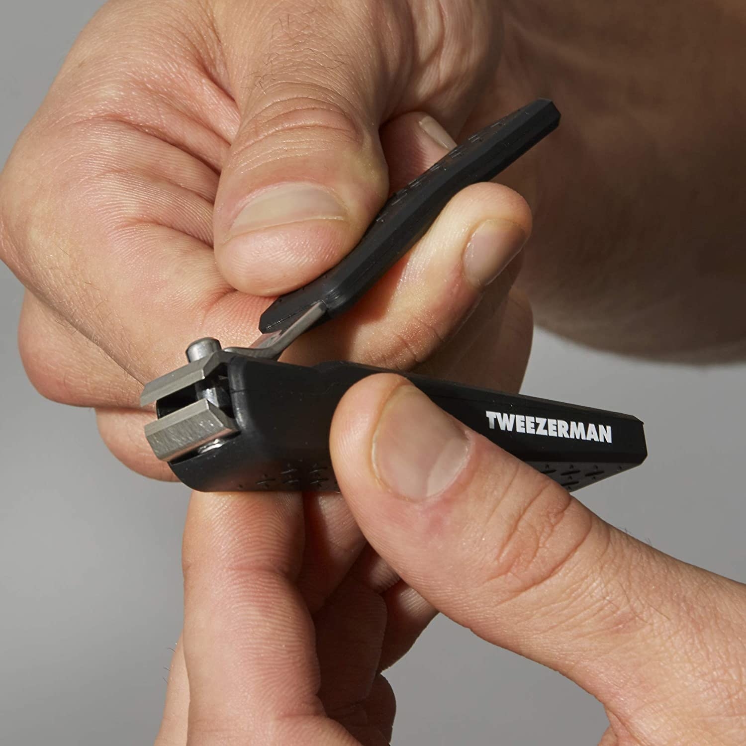 A person holding the tweezers