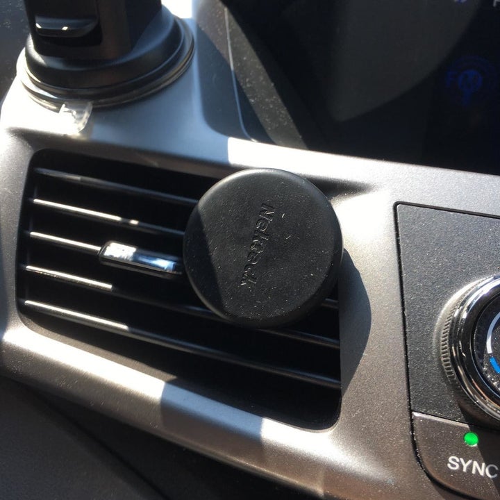 reviewer photo showing the magnetic mount attached to their vent 