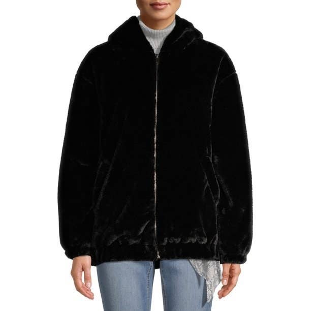 Model in zip-up faux fur hooded jacket