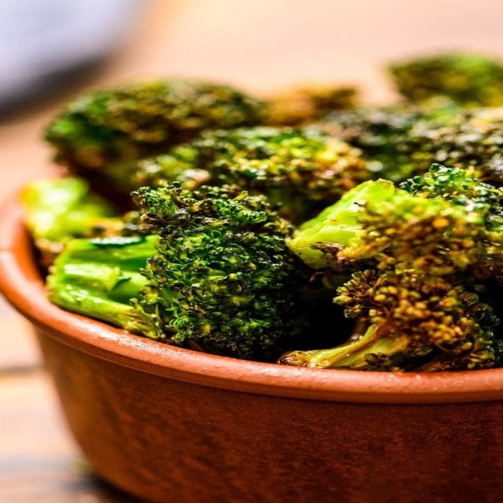 A bowl of crispy air fried broccoli.