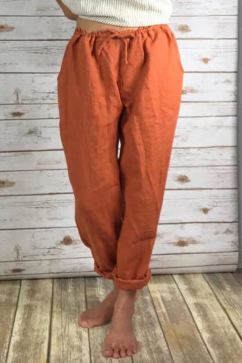 Front view of the same model wearing the rust pants and showing the drawstring waist
