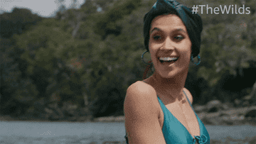 A GIF of character Falin laughing in a scene from &quot;The Wilds&quot;