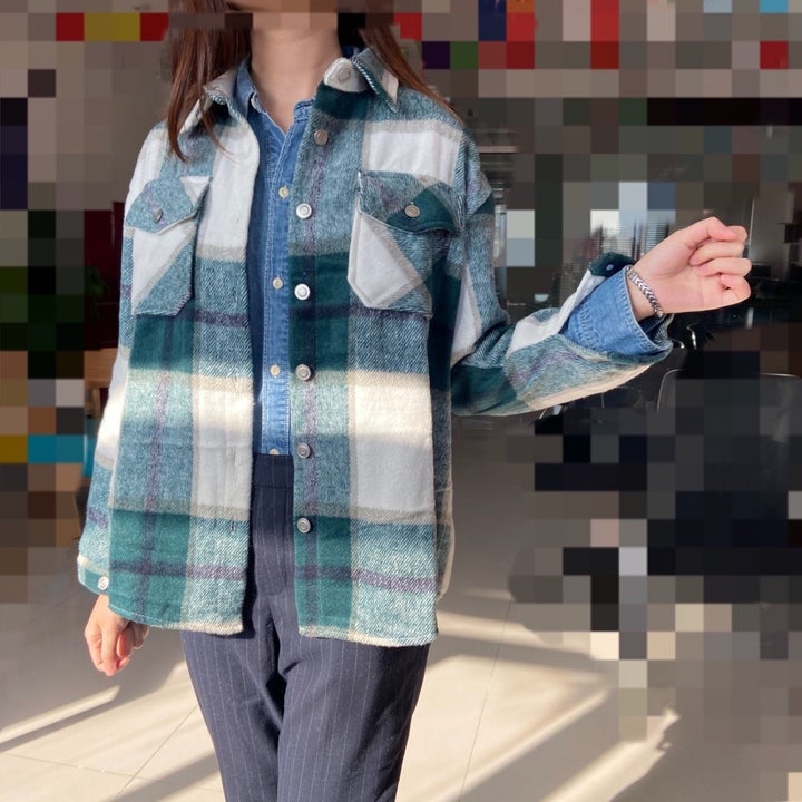 A reviewer wearing the green plaid version open like a jacket