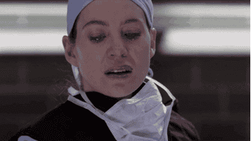 Meredith crying as she hands the bomb over in surgery