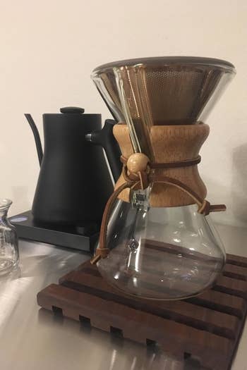 A pour-over coffee Chemex carafe with the reusable filter inserted at the top 
