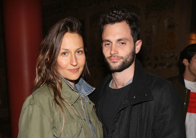 Domino Kirke and Penn Badgley posing next to one another