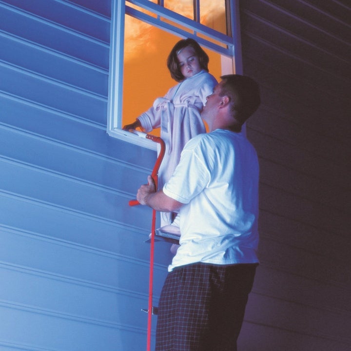 adult and young child using emergency escape ladder to get out of second-story window