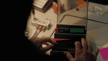 A person flips through a case of floppy disks