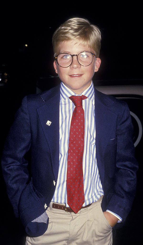 Peter Billingsley in 1986 with glasses in a suit