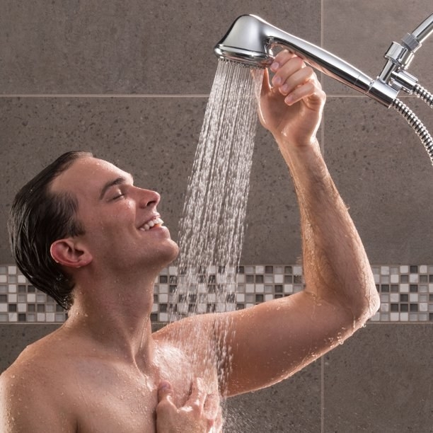 person using a removal shower head
