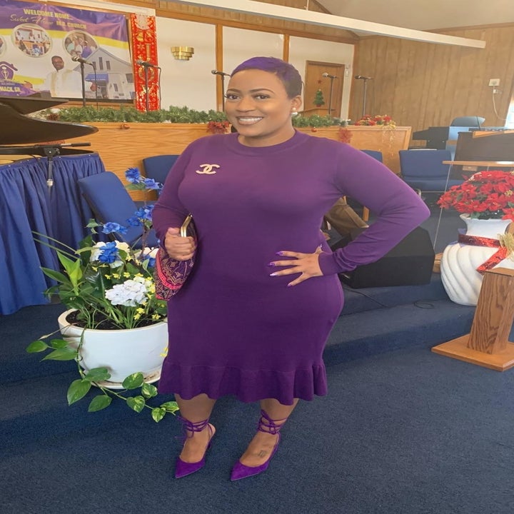 A reviewer wearing the long-sleeve dress in purple