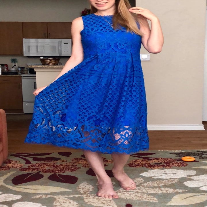 A reviewer wearing the fit and flare dress in royal blue