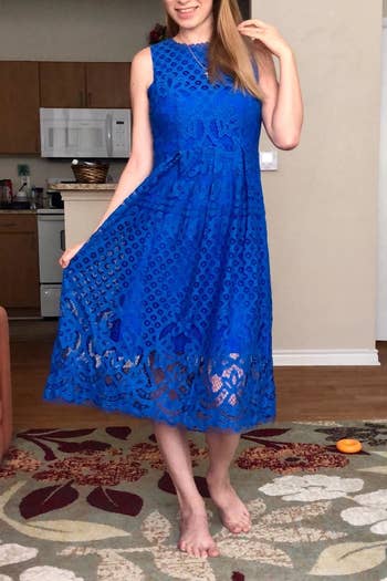 A reviewer wearing the fit and flare lace dress in royal blue