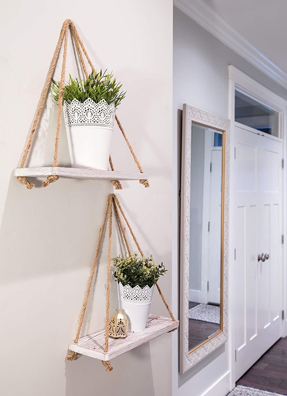A pair of rustic wall shelves hung with sisal rope in an entryway