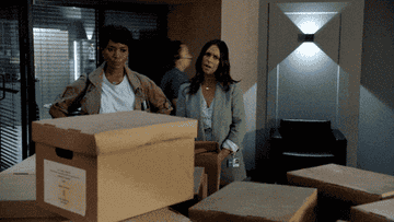gif of actor Angela Basset looking a table filled with boxes