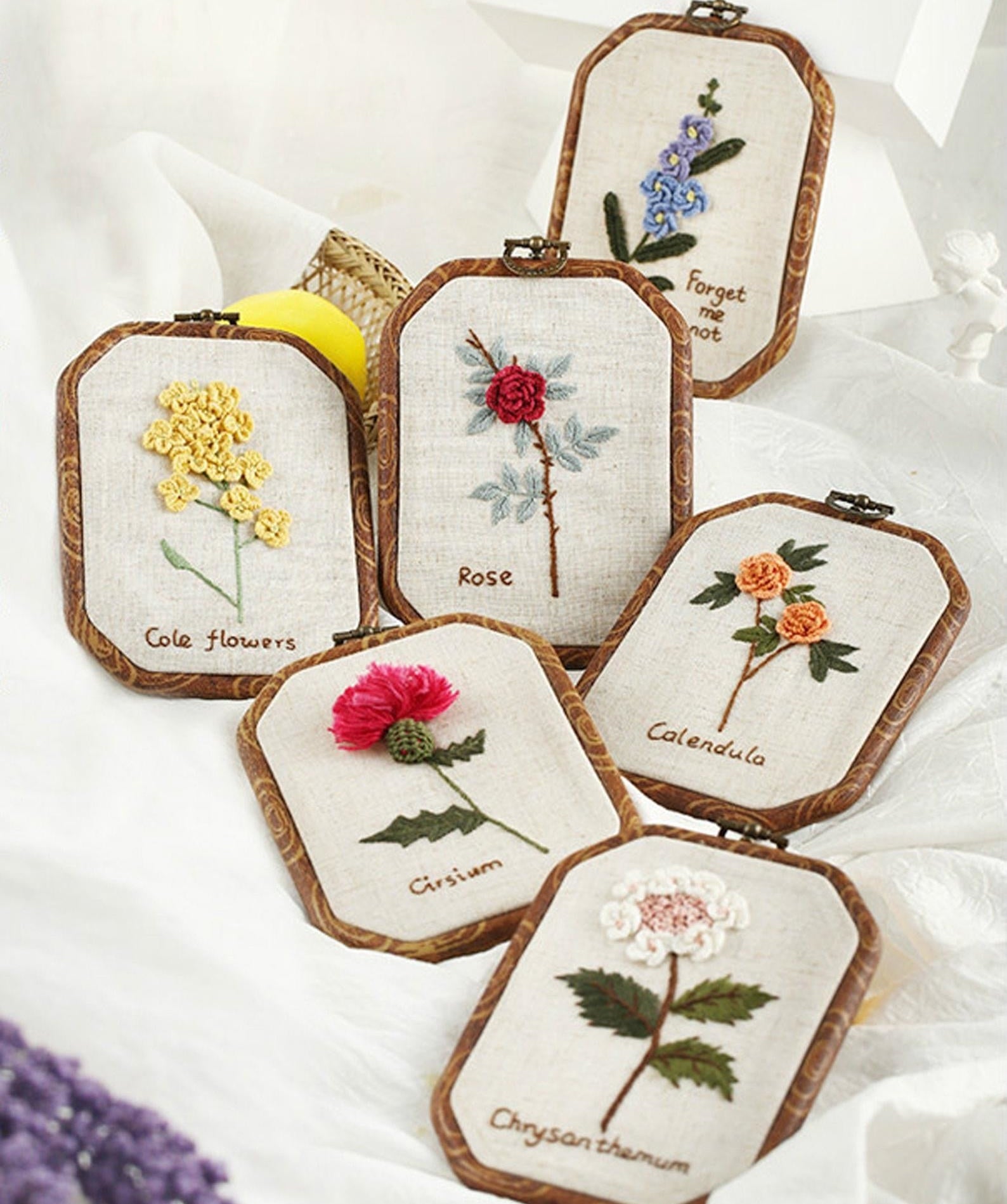 various embroidered flowers including a rose, cole flowers, calendula, forget me not, and more