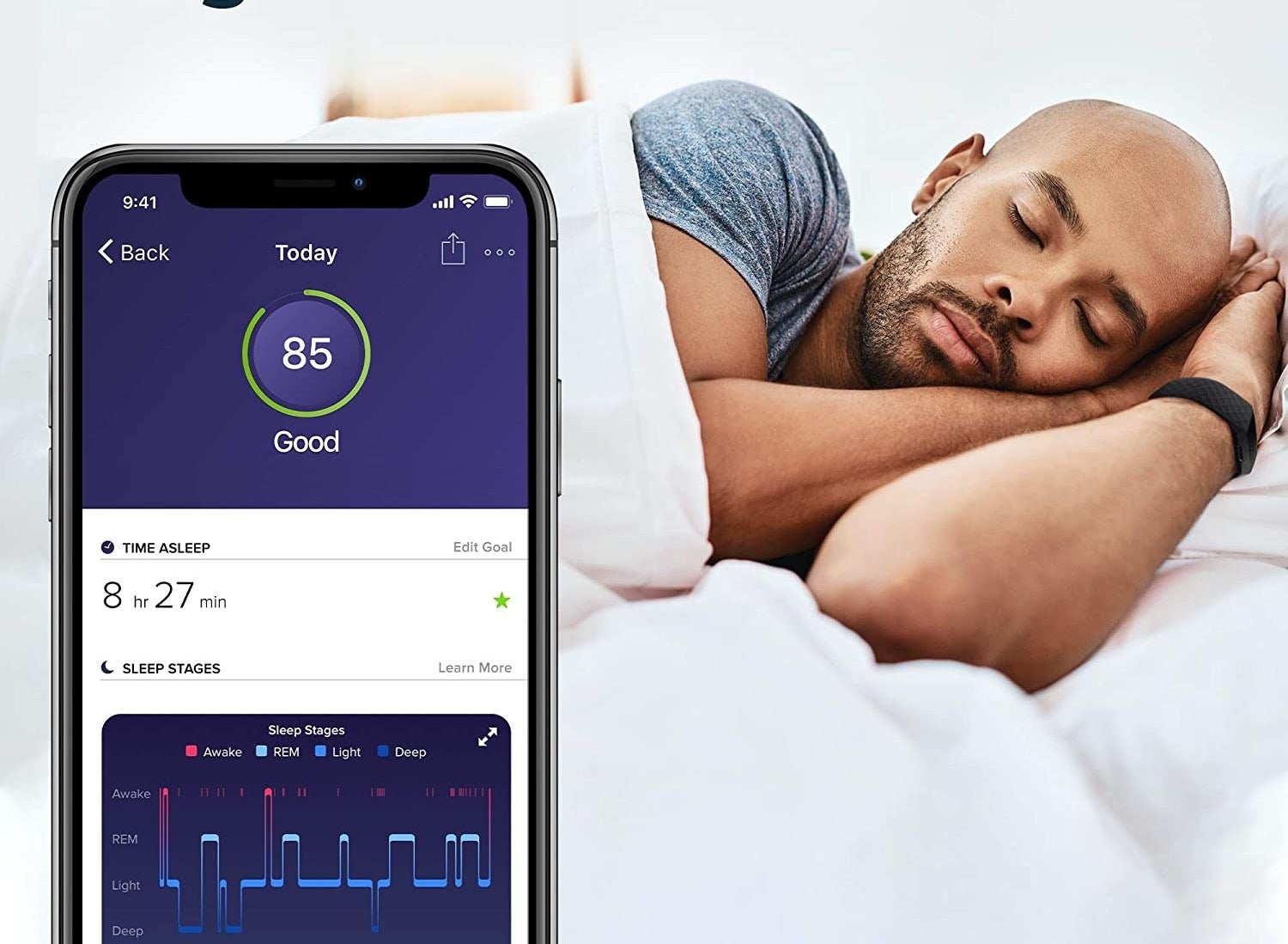 A person sleeping with the FitBit on and a phone tracking their patterns