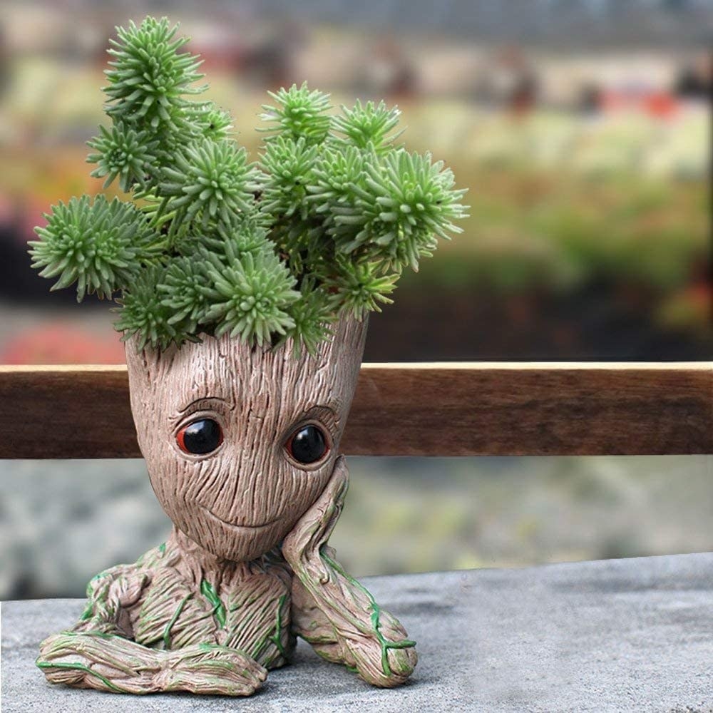 the groot planter with succulents in the top of his head