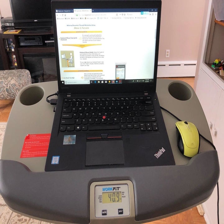 Reviewer desk bike in use with laptop on top