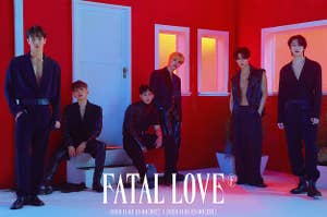 Monsta X poses outside of a house in leather outfits