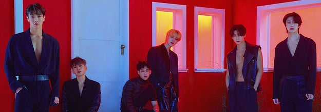 Monsta X poses outside of a house in leather outfits