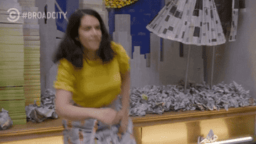 gif of Abbi Jacobson in the TV show &quot;Broad City&quot; kneeling down and putting her hand on her chin in front of a window