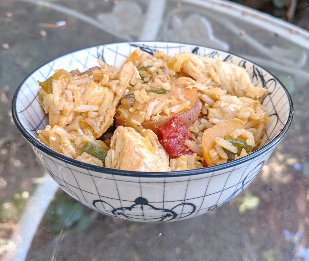 Bowl of fried rice with chicken, vegetables, and sweet potatoes