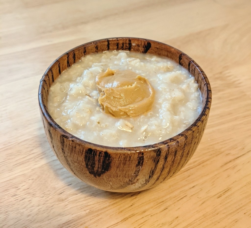 Bowl of oatmeal with a dollop of peanut butter