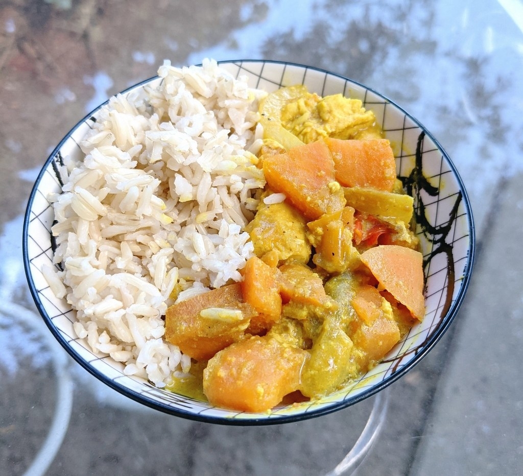 Bowl of rice and chicken curry with sweet potatoes